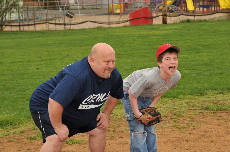 Ralph Heiser, left, demonstrates defensive positioning to Christopher Brothers during a Miracle League baseball practice. Heiser started as a volunteer coach for the Columbia River Miracle League.