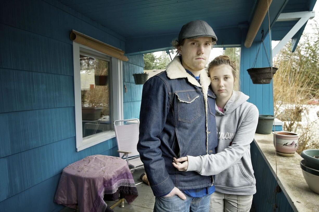 Harly and Courtney Forbes stand on the front porch where their tandem bicycle, which was locked, was stolen during the early morning hours Monday.