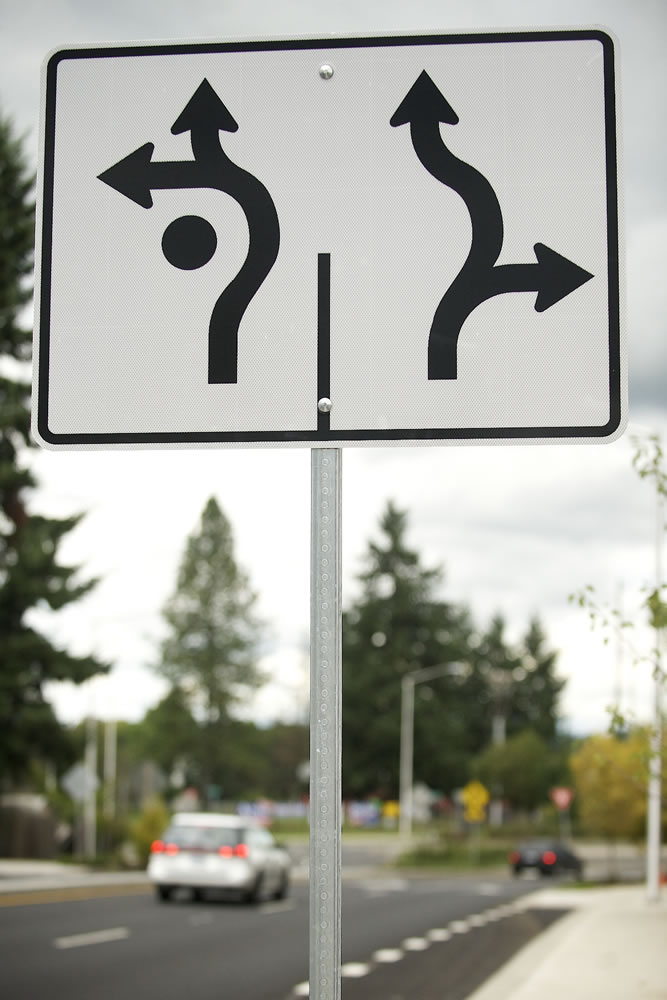 A traffic sign alerts motorists as they navigate their way around a new roundabout on Sept.