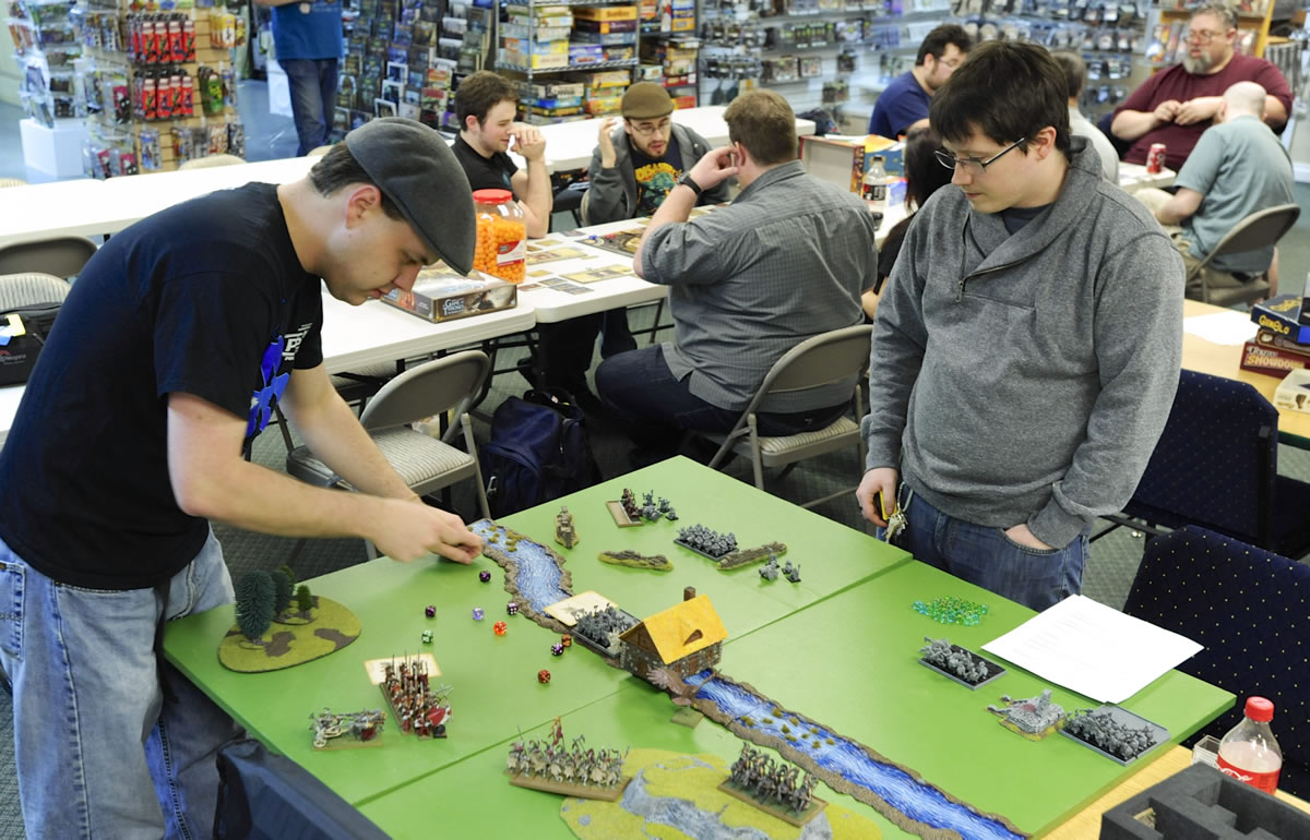 Board gamers Pete Harper, left, and Jake Hermens make their moves on a War Hammer Fantasy Battle at the Dice Age store March 15 in Vancouver.