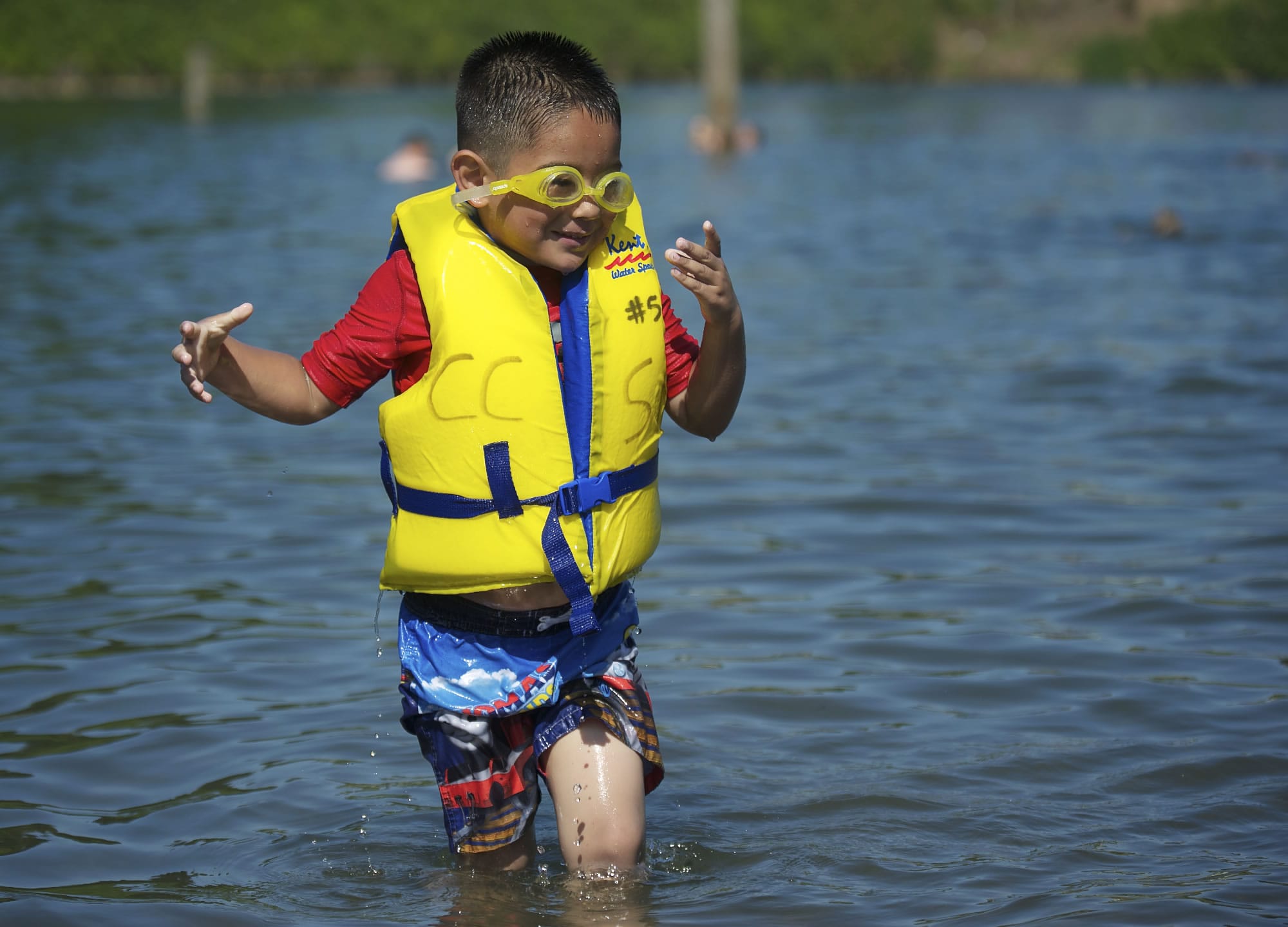 Esteban Cervantes, 4, of Vancouver wears a life jacket Friday at Klineline Pond. The popular swimming site hasn't had lifeguards since budget cuts in 2009, but beginning this week, about a dozen life jackets in a full range of sizes are available to borrow.