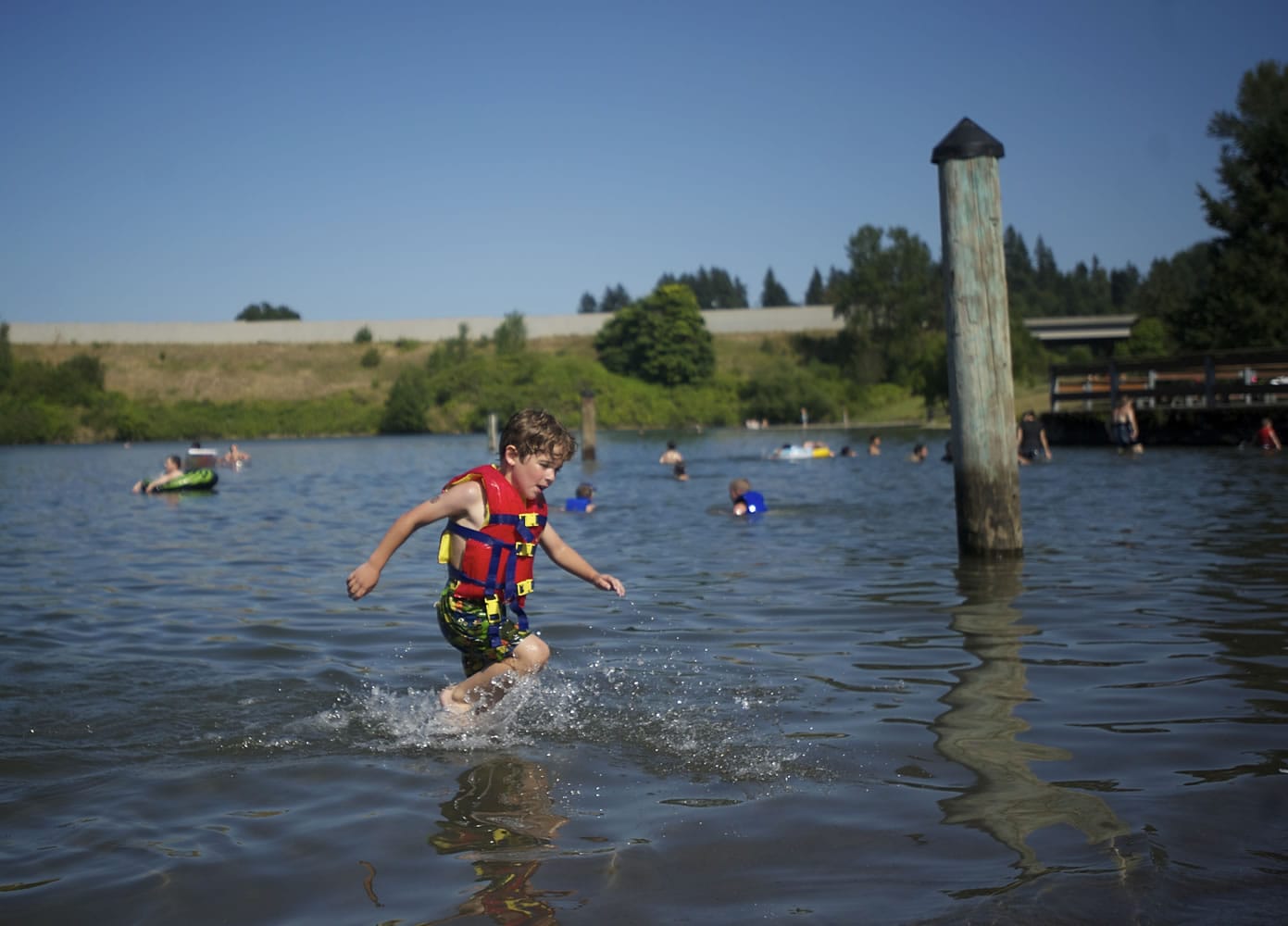 Devyn Thomas of Vancouver runs back to shore during a recent summer at Klineline Pond.