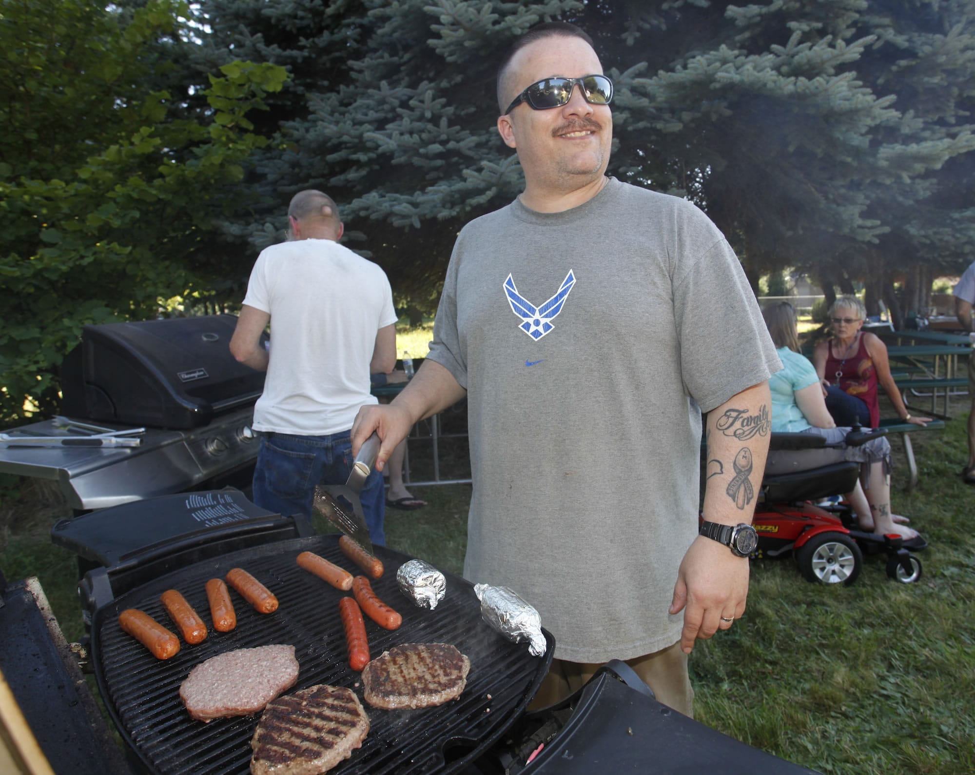 Jaime Manriquez, chairman of the Landover-Sharmel Neighborhood Association, grills food at a July 20 picnic.