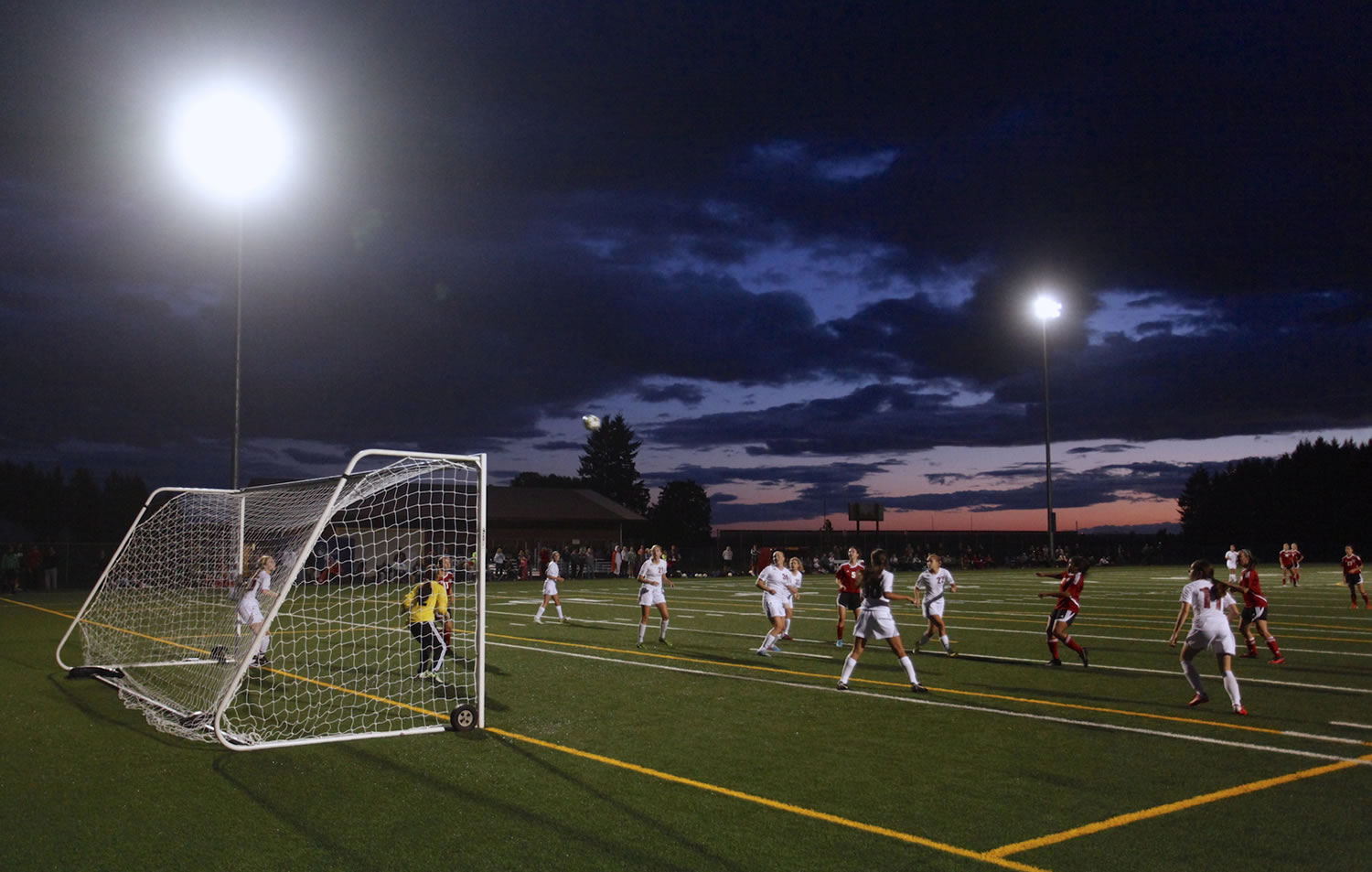 The Prairie and Camas girls soccer teams play the first night match under the newly installed lights at Prairie High School's on-campus field.