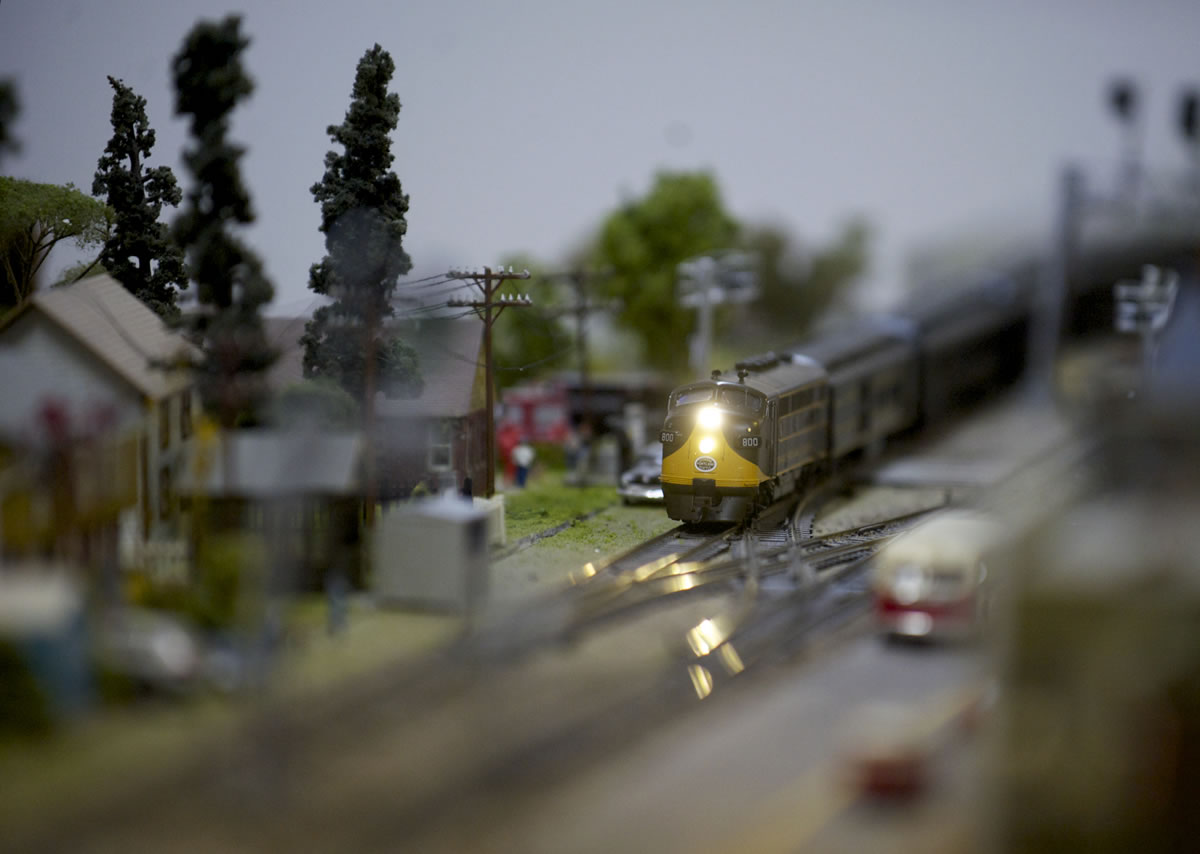 A model train rumbles through a miniature town during the Southwest Washington Model Railroaders open house Saturday.
