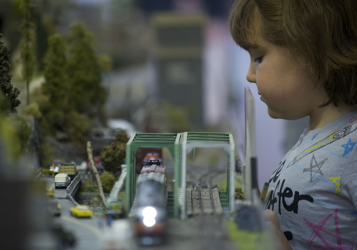 Adriana Castanon, 10, of Vancouver, gets a closer look at a passing train during the Southwest Washington Model Railroaders open house at their clubhouse on Saturday.