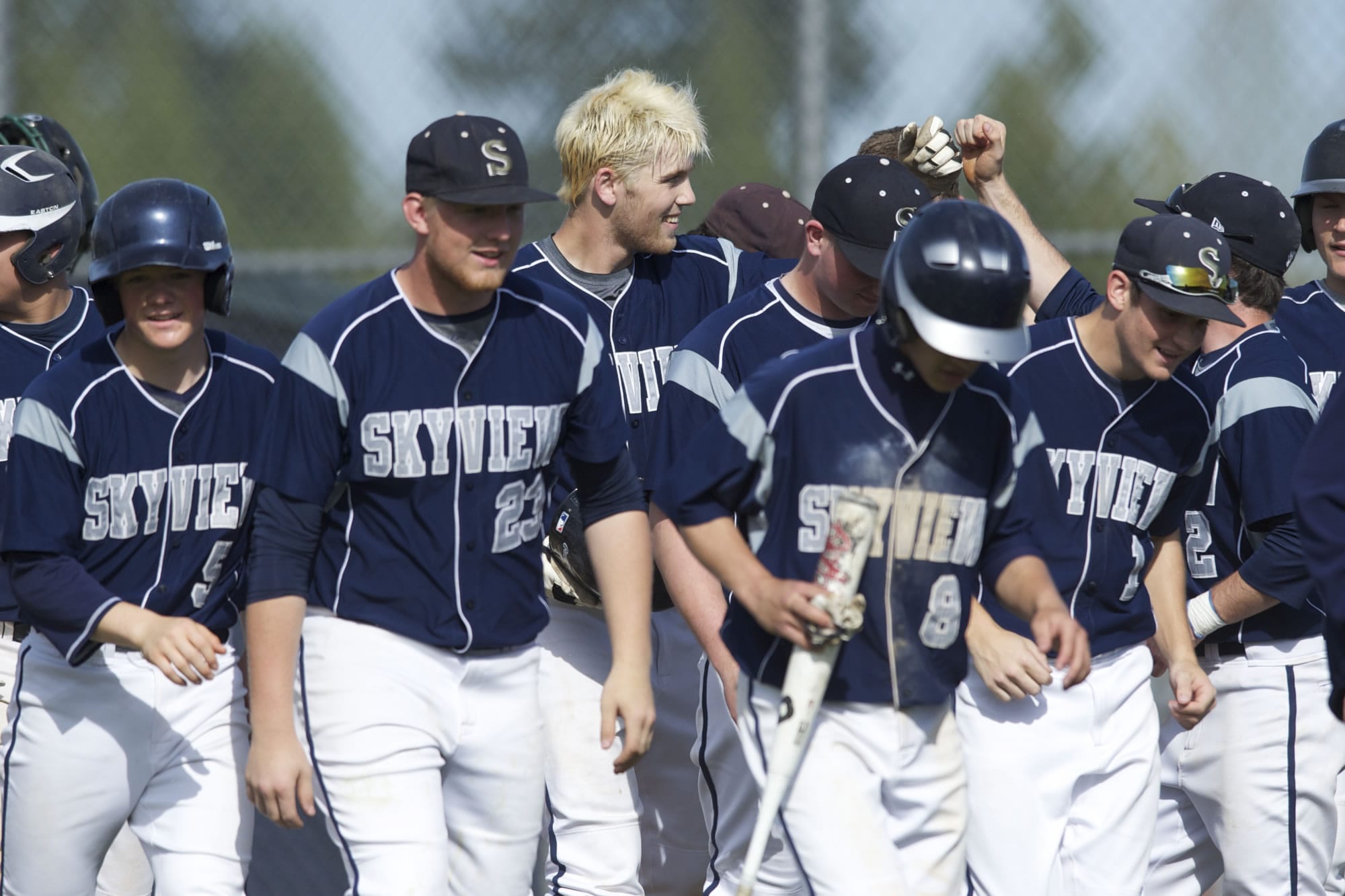 Skyview baseball player Brayden Maney is congratulated by teammates after he hit a grand slam in the league finale Friday against Heritage.