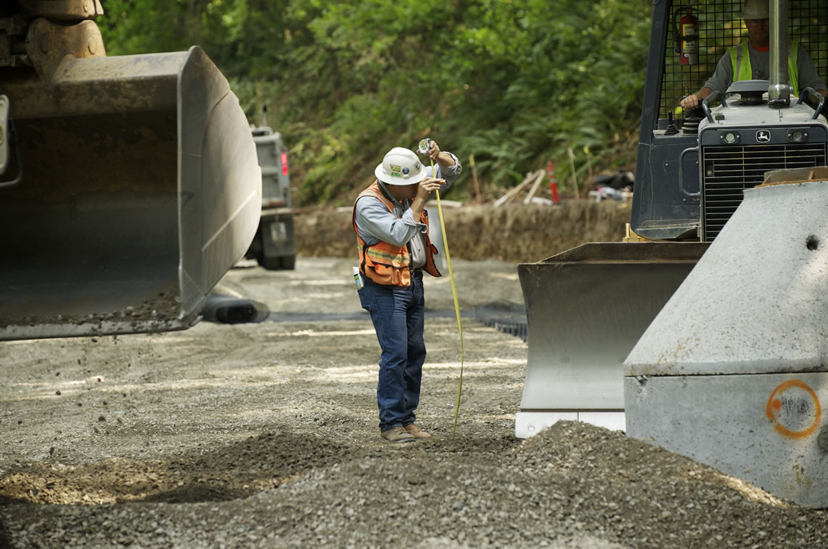 Project superintendent Jim Jollie surveys a section of Northwest Pacific Highway, north of La Center, as it is rebuilt, Friday, Aug 10.