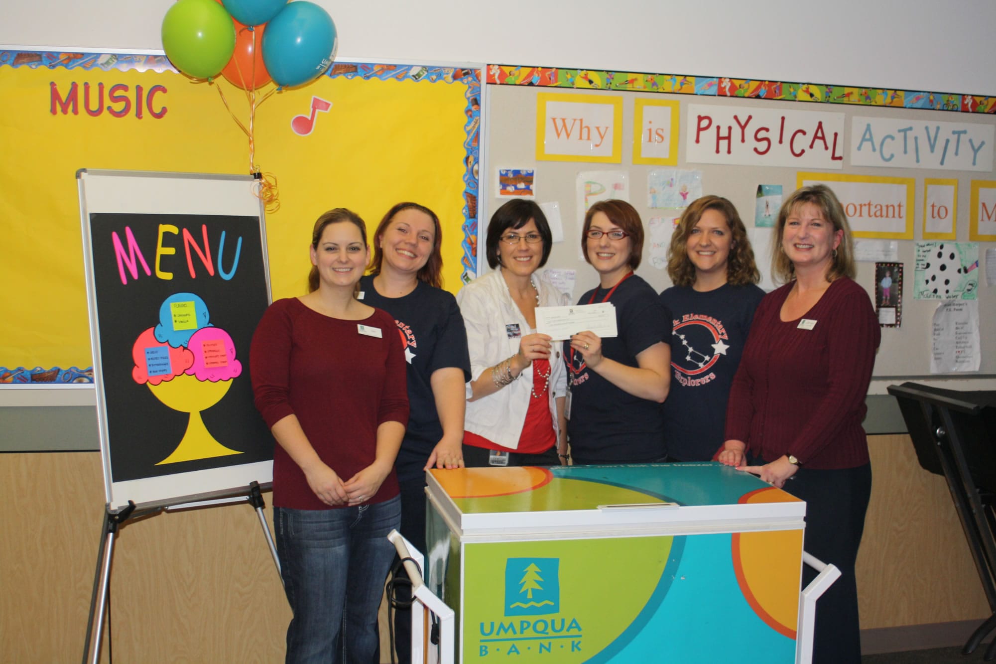 North Sifton: Amy Huff, from left, Ginny Gronwoldt, Dawn Harris, Carrie Torrance, Tami Eldredg and Lori Wick get a check for $2,000 from Umpqua Bank's Give Back to School Fund.