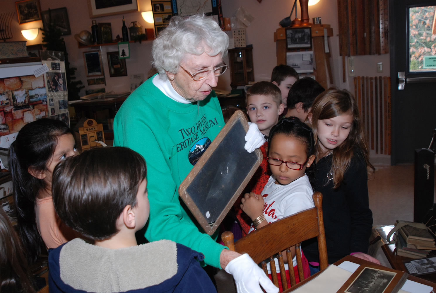 Washougal: Hathaway Elementary School students learn how small chalk boards were used at school in the &quot;olden days&quot; from Two Rivers Heritage Museum volunteer Cynthia Purdy.