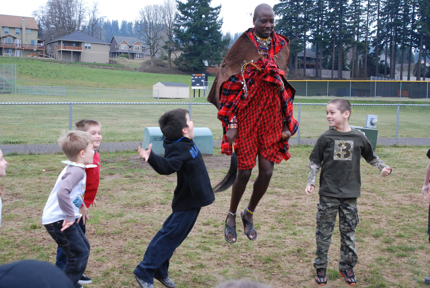 Washougal: Maasai warrior Sabore Ole Oyie from Kenya shows Gause Elementary second-graders Kaleb Murray, from left, Connor Fisk, Caiden Zipperlend  and Otto LeBeau a dance to celebrate a successful lion hunt.
