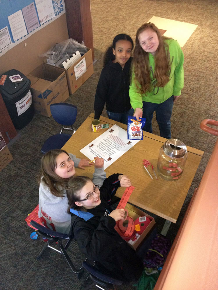 Camas: Grass Valley fifth-graders Megan Bauer, seated left, and Lily Thompson, seated right, accept donations from Hossana Abbay, top left, and Autumn Aho at a donation drive for the Humane Society for Southwest Washington.