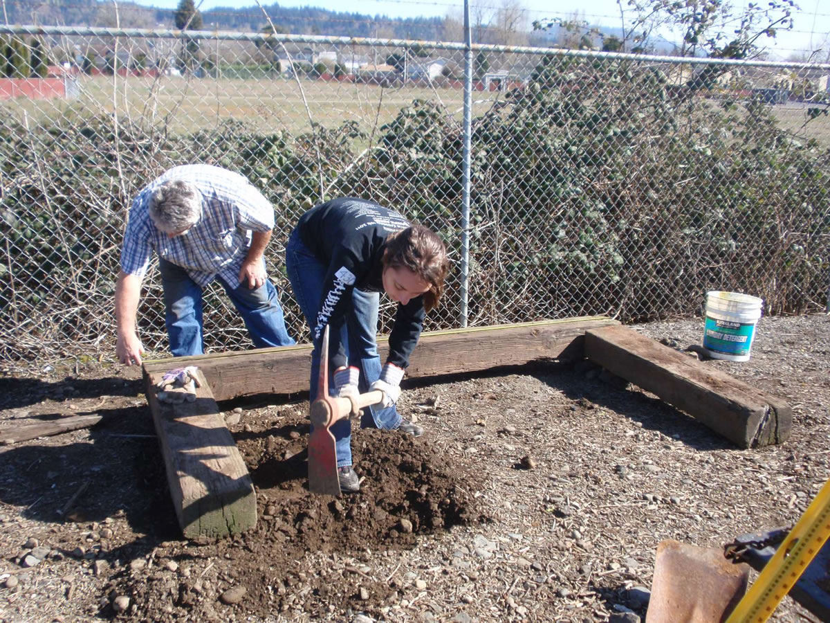 Woodland: Rick Kitchen, left,  and Jamie Kitchen began work in February on a garden memorial near the train tracks where teens Eddie Denson and Katie Blacklaw were killed on April 14, 2009.