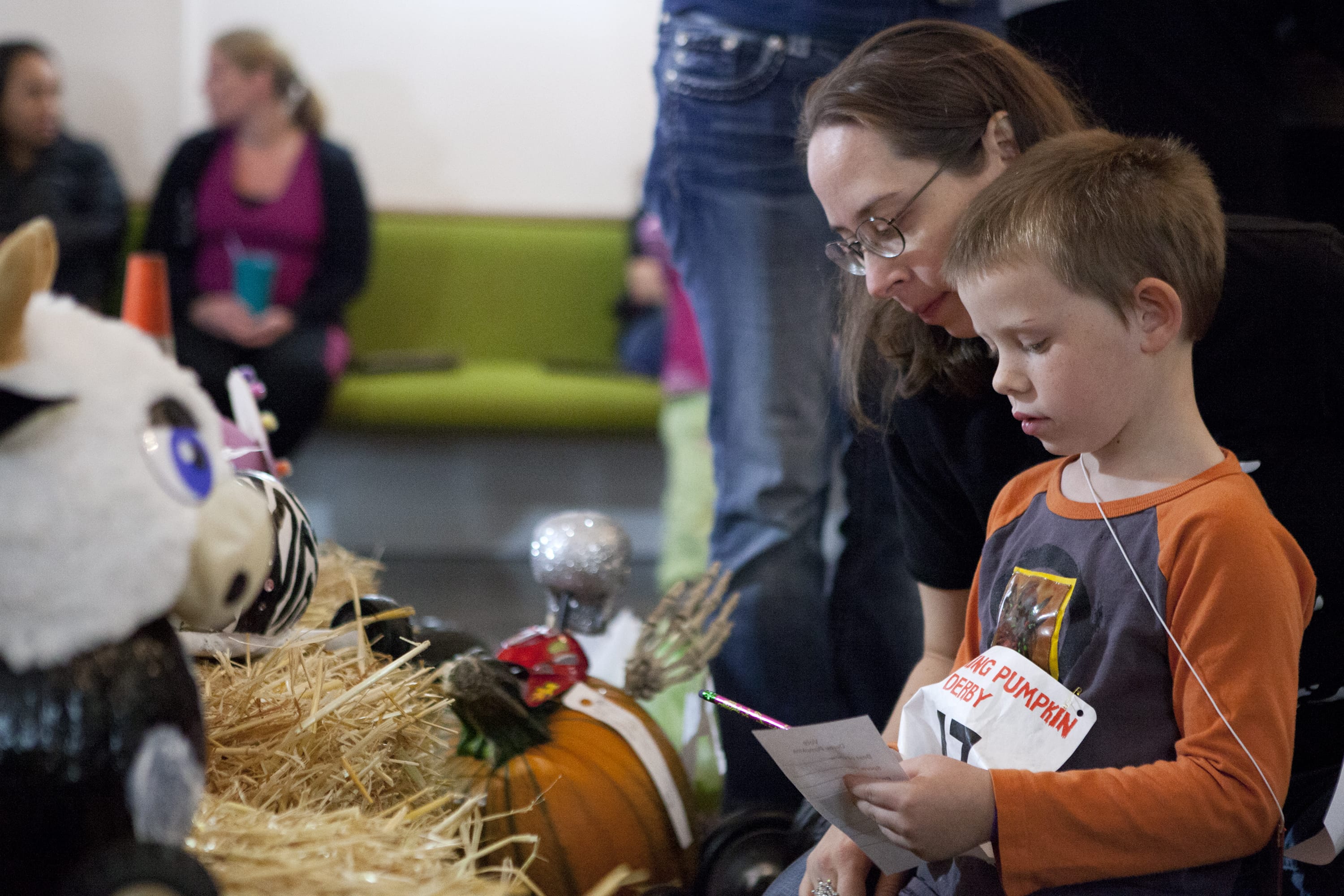 William Sturgil, 5, and his mother, Heather Sturgil, judge pumpkins at the third annual Screaming Pumpkin Derby.