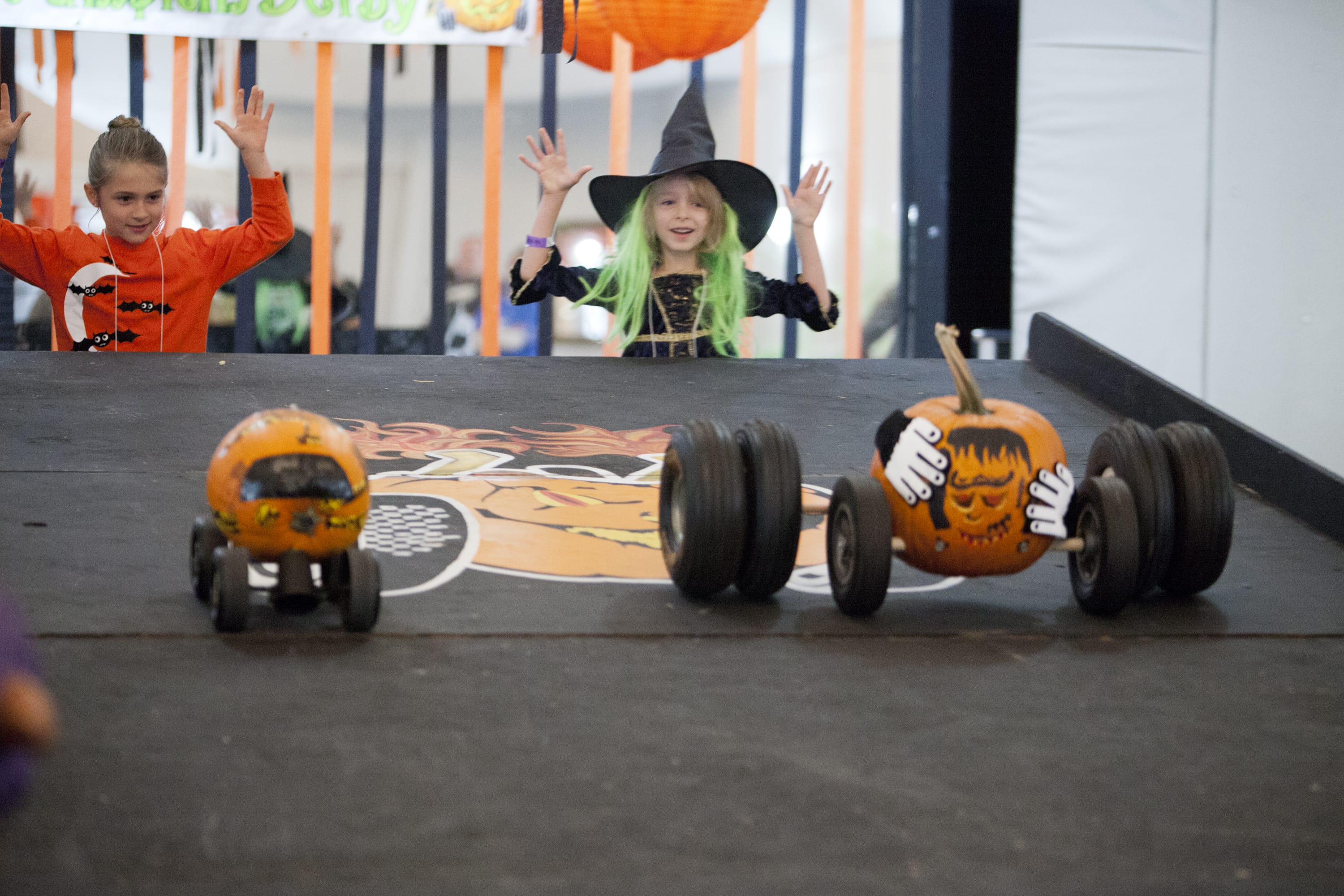 Photos by Vivian Johnson for The Columbian
Callie Kahler, right, races her Freaky Frankie Frank pumpkin at the Screaming Pumpkin Derby at Serendipity's Event Center.   Below, beyond pumpkin racing, the Screaming Pumpkin Derby also included several kids activities and a costume contest.