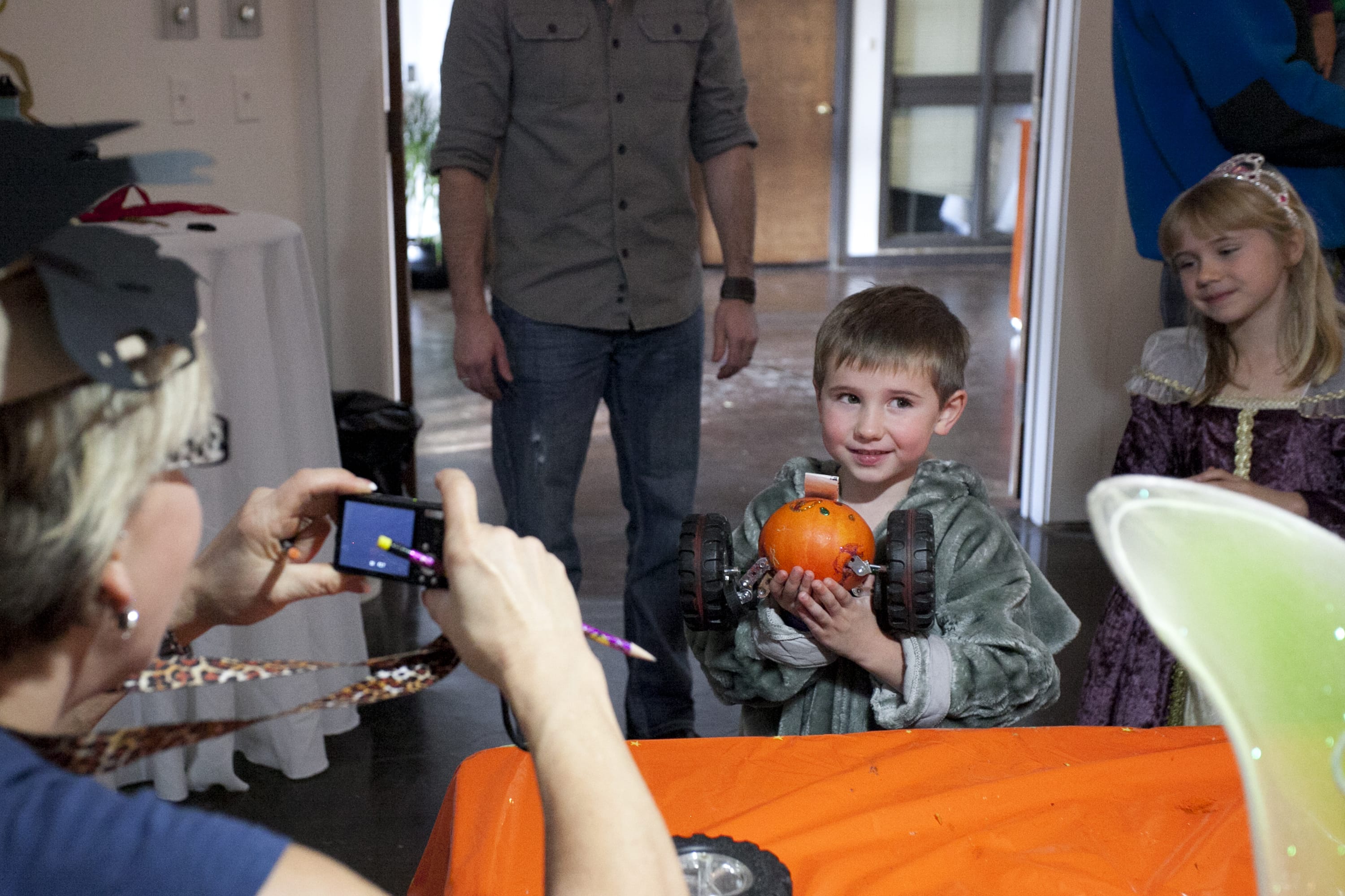 John Snapp, 4, gets his picture taken with his derby pumpkin as his sister Stephanie, 6, looks on at the Screaming Pumpkin Derby.