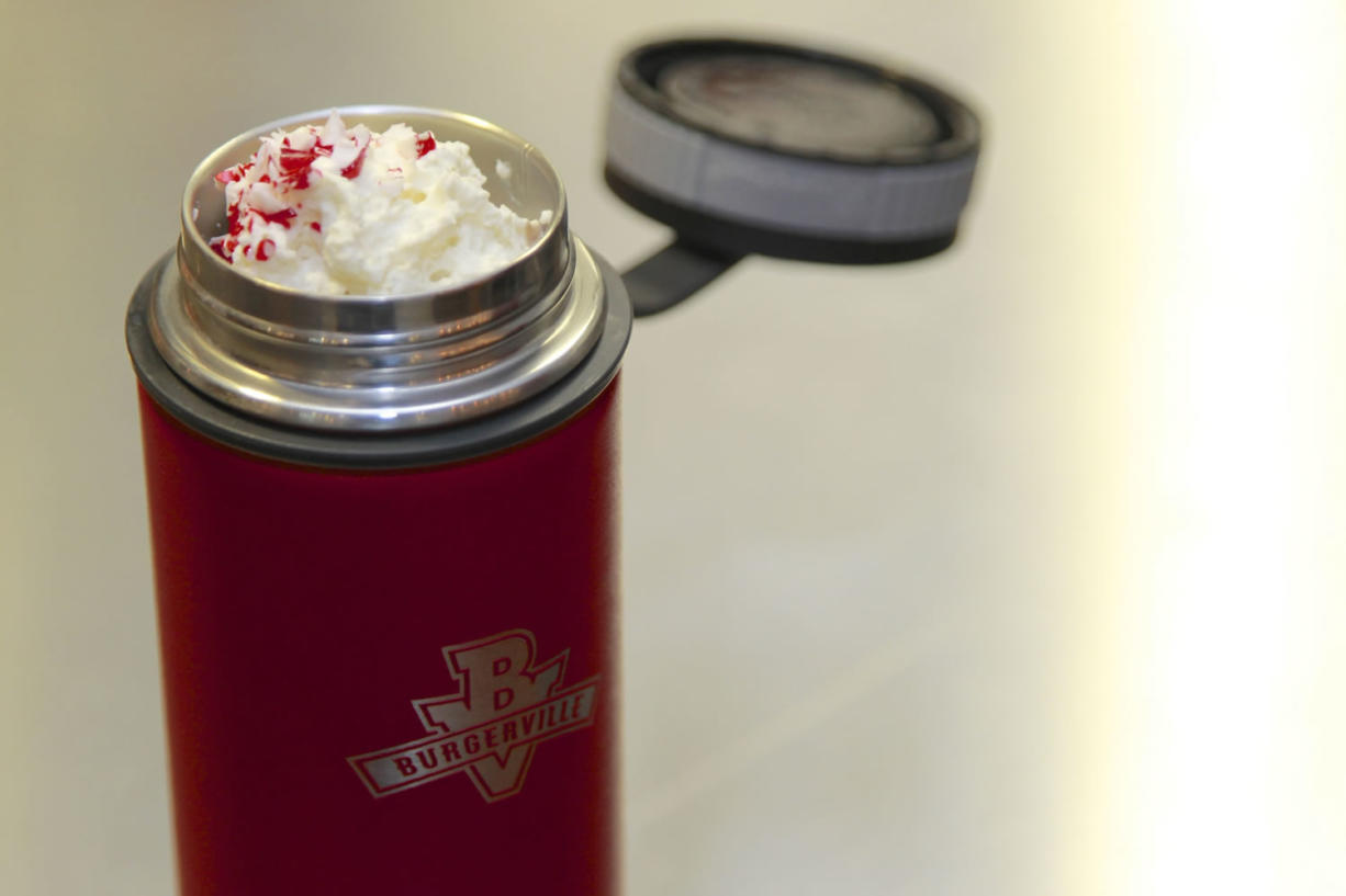 A stainless-steel Hydroflask travel mug sold at the Burgerville at Portland International Airport keeps this chocolate-peppermint milkshake cold for a cross-country flight. The Vancouver-based restaurant chain says it will sell the mug at other outlets for those taking long road trips. Additional innovations tested at the PDX Burgerville are also being implemented at other locations.