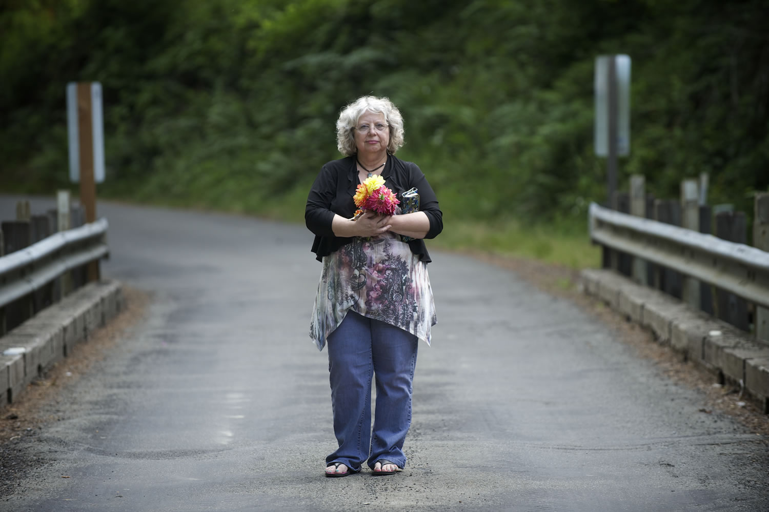 Starr Lara poses for a portrait July 12 on a bridge where some of her sister's belongings were found. Convicted killer Warren L. Forrest is suspected in connection with the disappearance of Lara's sister, Jamie Grissim, in 1971.