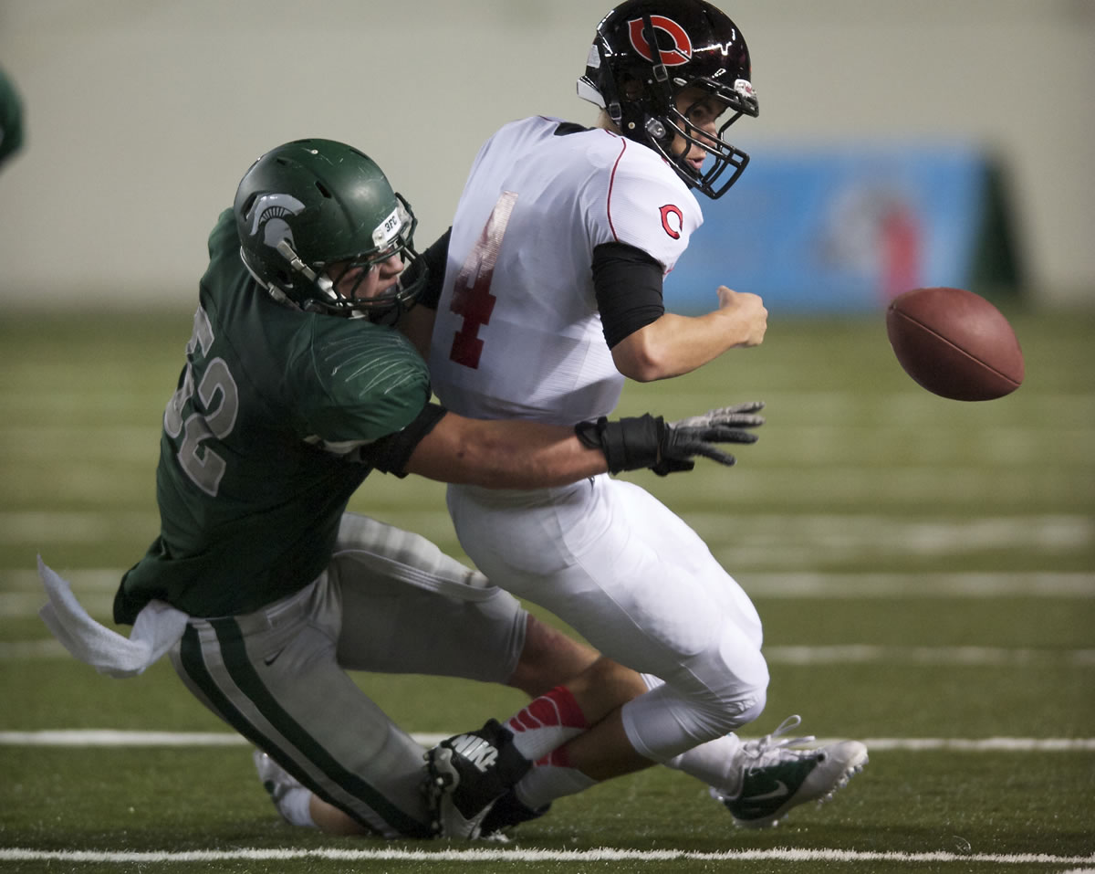 Skyline's Peyton Pelluer stops any hope of a Camas fourth quarter comeback after he forces a fumble by Camas quarterback Reilly Hennessey during a 4A semifinal match-up at the Tacoma Dome on Saturday November 24, 2012.