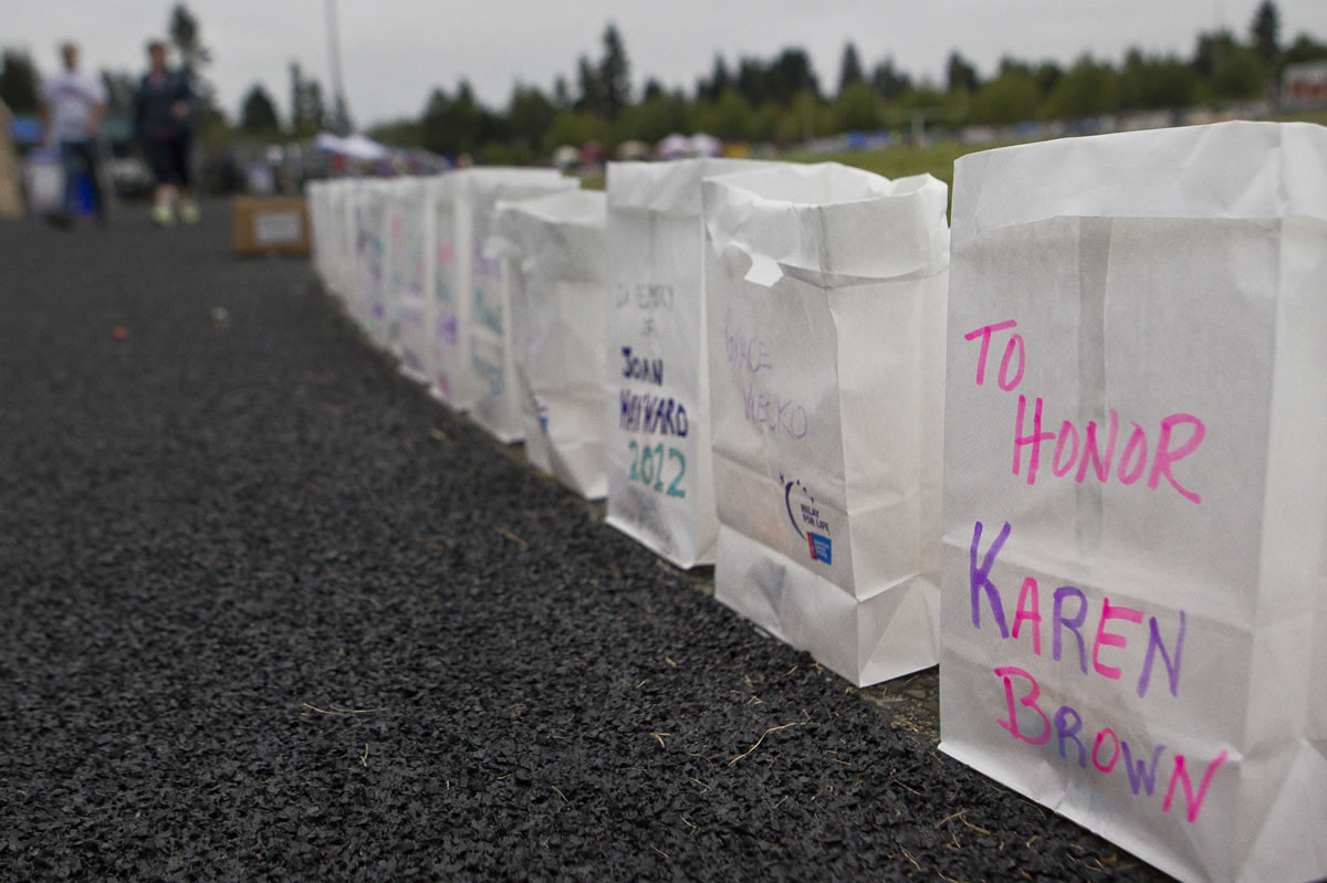 Candlelit bags (luminarias) line the Relay for Life track Sunday.
