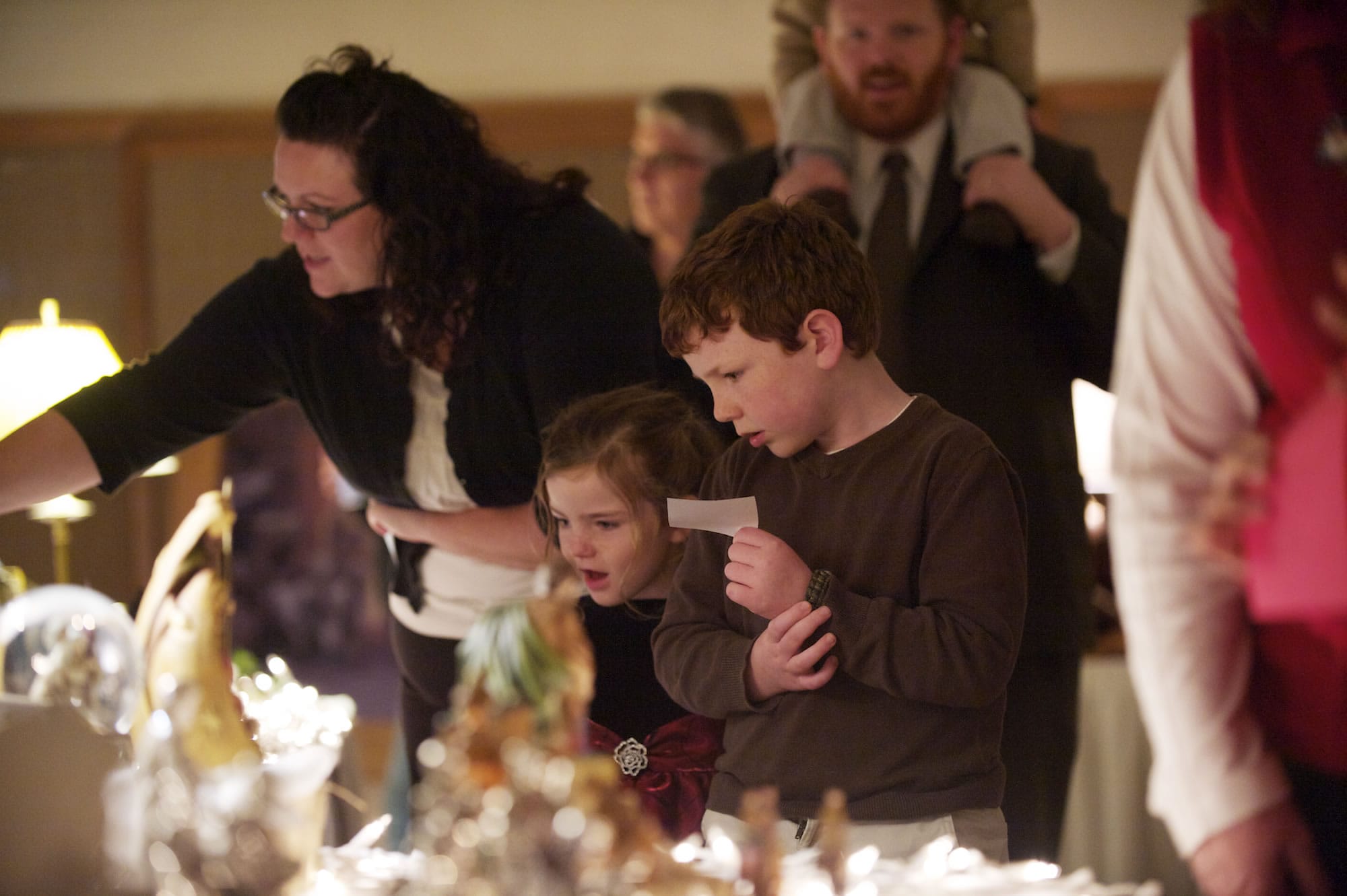 Collin Horrocks, 7, his sister, Hadley Horrocks, 4, and their mom, Katie Horrocks, get a close view of a nativity from a foreign land on Sunday at The Church of Jesus Christ of Latter-day Saints in east Vancouver.