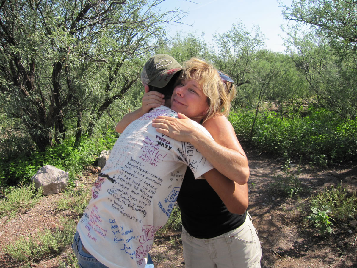 Jill Campbell embraces a &quot;hiker&quot; she encountered in the Arizona desert.