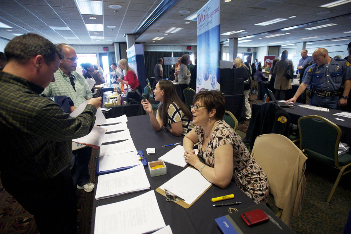 Tyson Jones, 37, left, from Vancouver, speaks with TMG's Director of Human Resources Sharon Jutila during a  jobs fair at the Red Lion at the Quay on May 23.