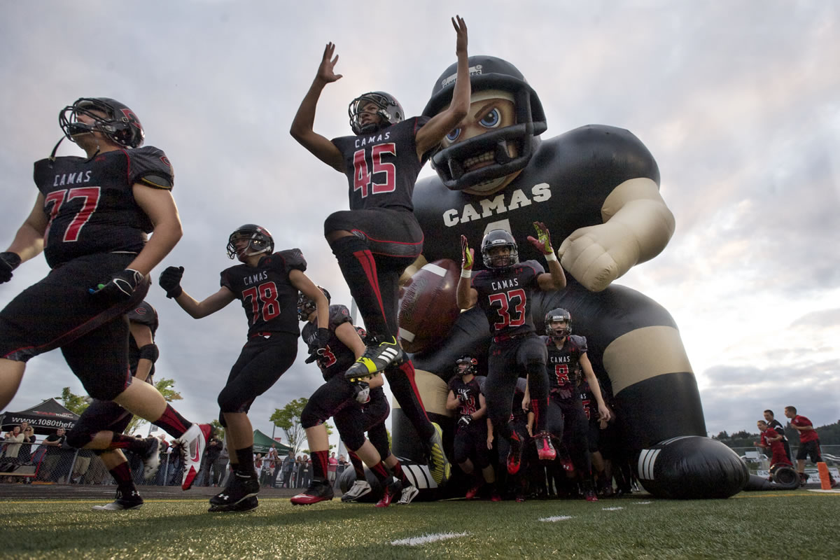 The Camas High School football team takes the field for the first game of the season against Jesuit High School.
