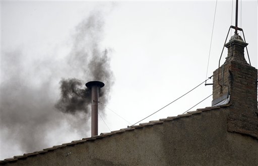 Black smoke emerges from the chimney on the roof of the Sistine Chapel, in St. Peter's Square at the Vatican, Wednesday, March 13, 2013.