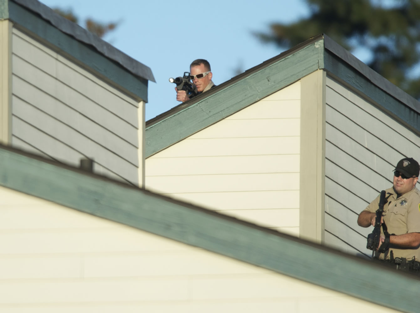 Sheriff's deputies stood by with less-than-lethal weapons Saturday during the standoff.