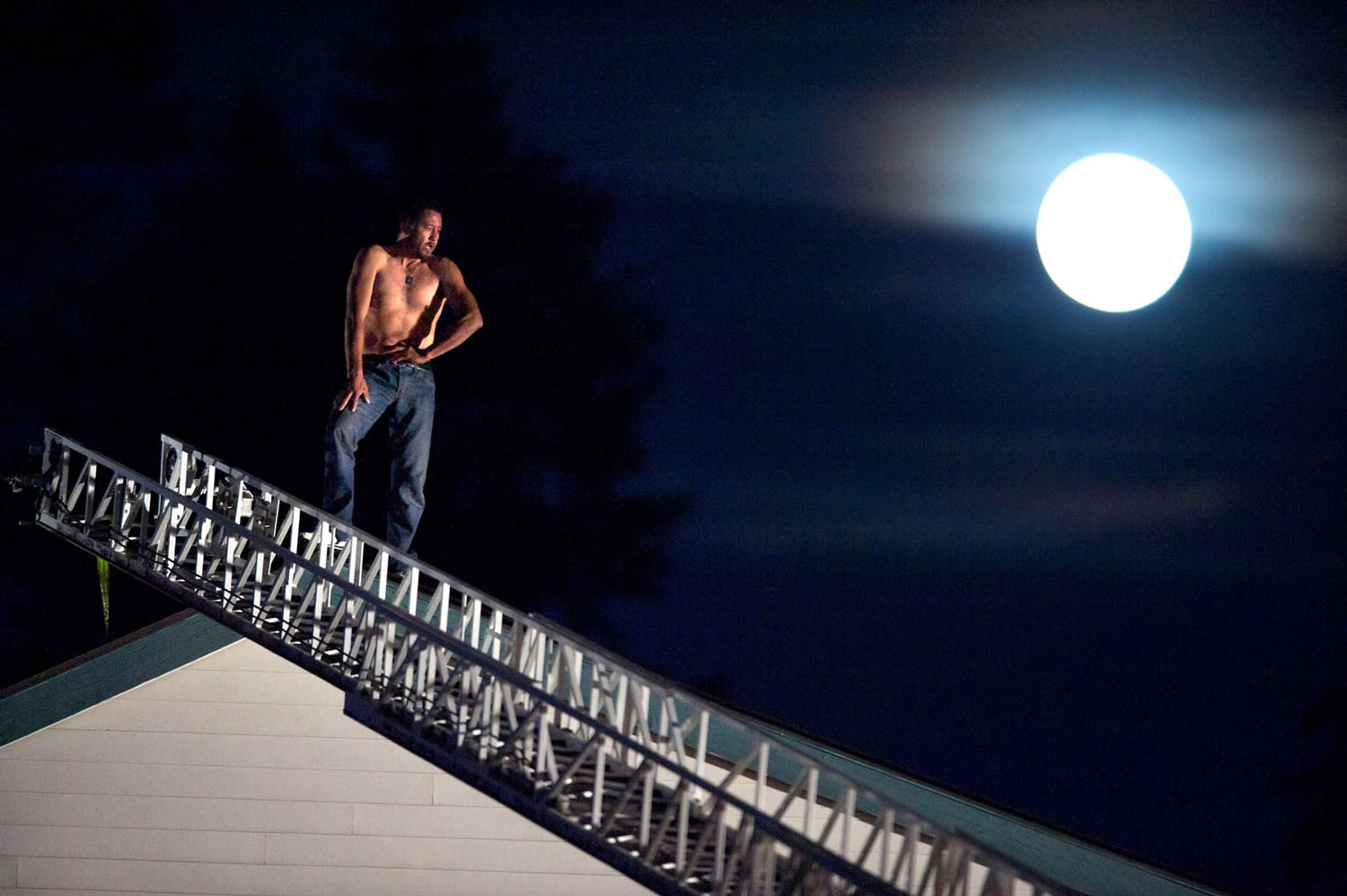 As the harvest moon rises behind him, a man identified as Angel M.