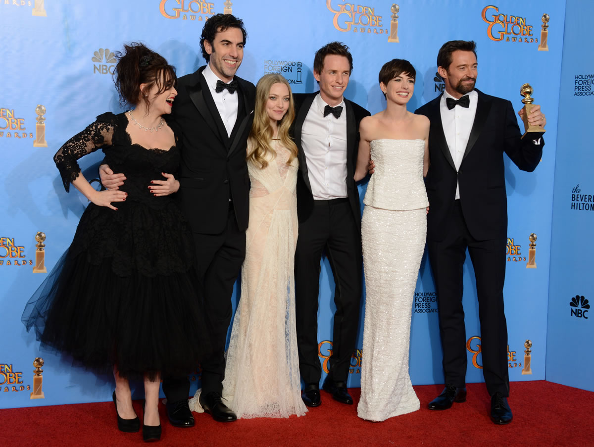Actors, from left, Helena Bonham Carter, Sacha Baron Cohen, Amanda Seyfried, Eddie Redmayne, Anne Hathaway and Hugh Jackman pose Sunday with the award for best motion picture comedy or musical for &quot;Les Miserables&quot; backstage at the 70th Annual Golden Globe Awards at the Beverly Hilton Hotel in Beverly Hills, Calif.