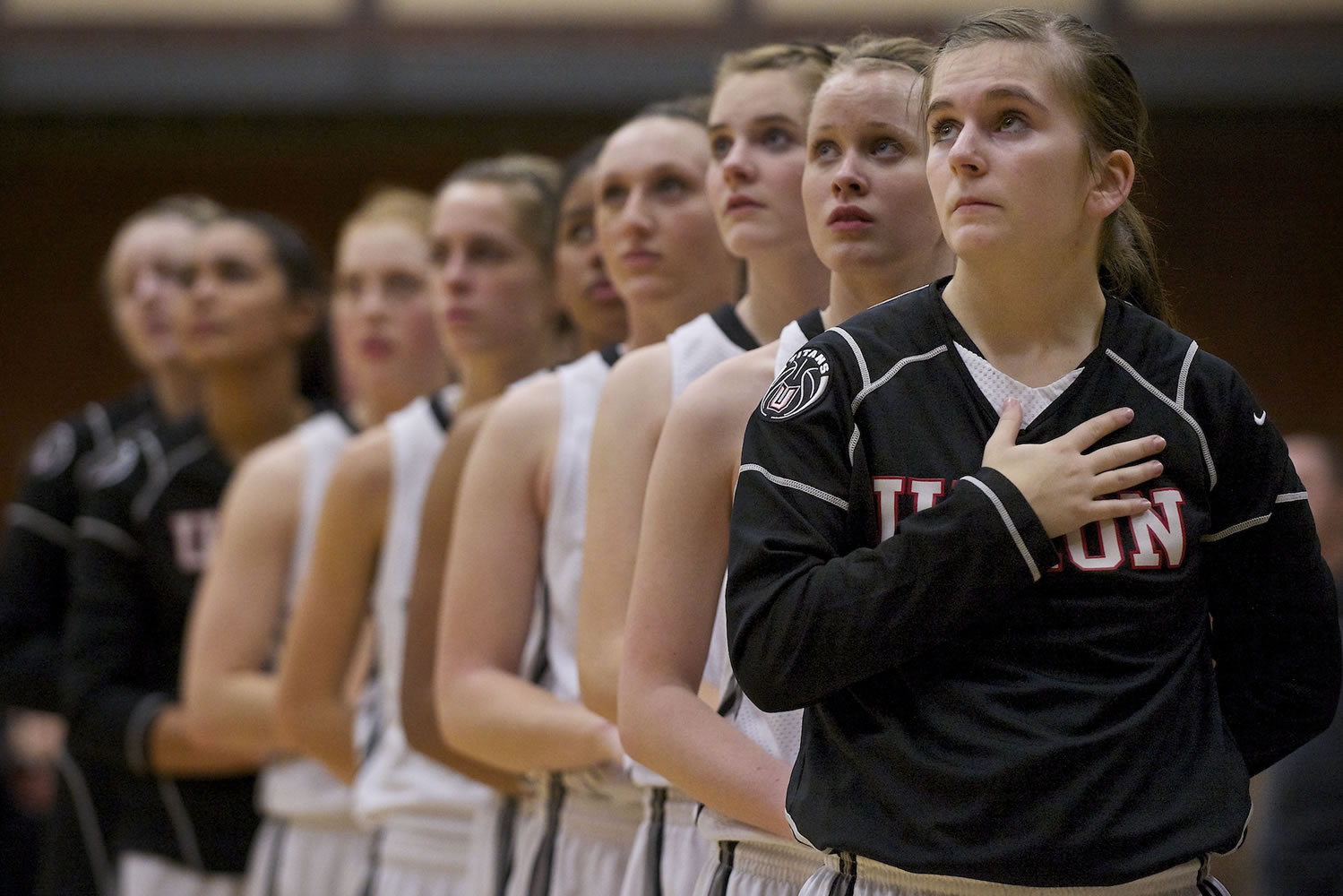 Kendra Preuninger, foreground, stands with her teammates before the start of a game Tuesday.