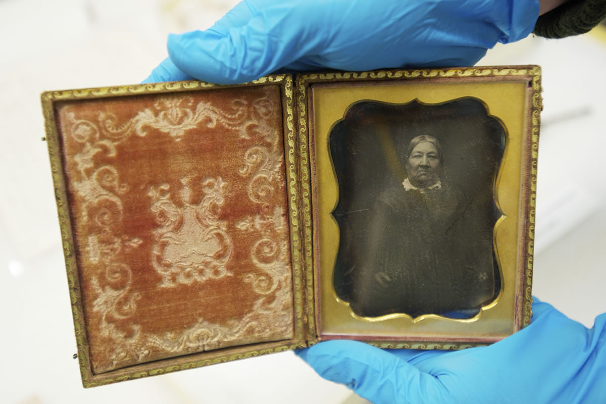 Meagan Huff, museum technician at Fort Vancouver National Historic Site, shows a daguerreotype that is the only known image of Marguerite McLoughlin.