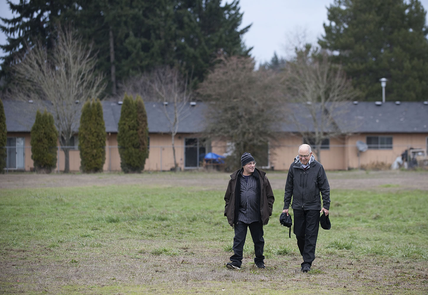 Adam Kravitz, left, founder of Outsiders Inn, strolls with Bill Ritchie of the Clark County Commission on Aging on Dec. 3 outside Safe Harbor Church of the Nazarene in Vancouver, where the Council for the Homeless had planned to build a village of 40 tiny houses for the homeless. Wednesday, the church backed out of the project, and organizers are looking for a new site.