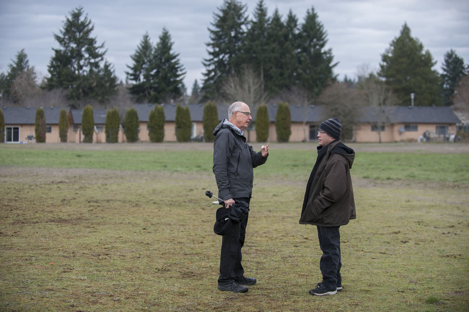 Bill Ritchie, chairman of the Clark County Commission on Aging, left, chats Thursday with Adam Kravitz, future site manager of the village for the homeless that will be built in a field at Safe Harbor Church of the Nazarene in Vancouver.