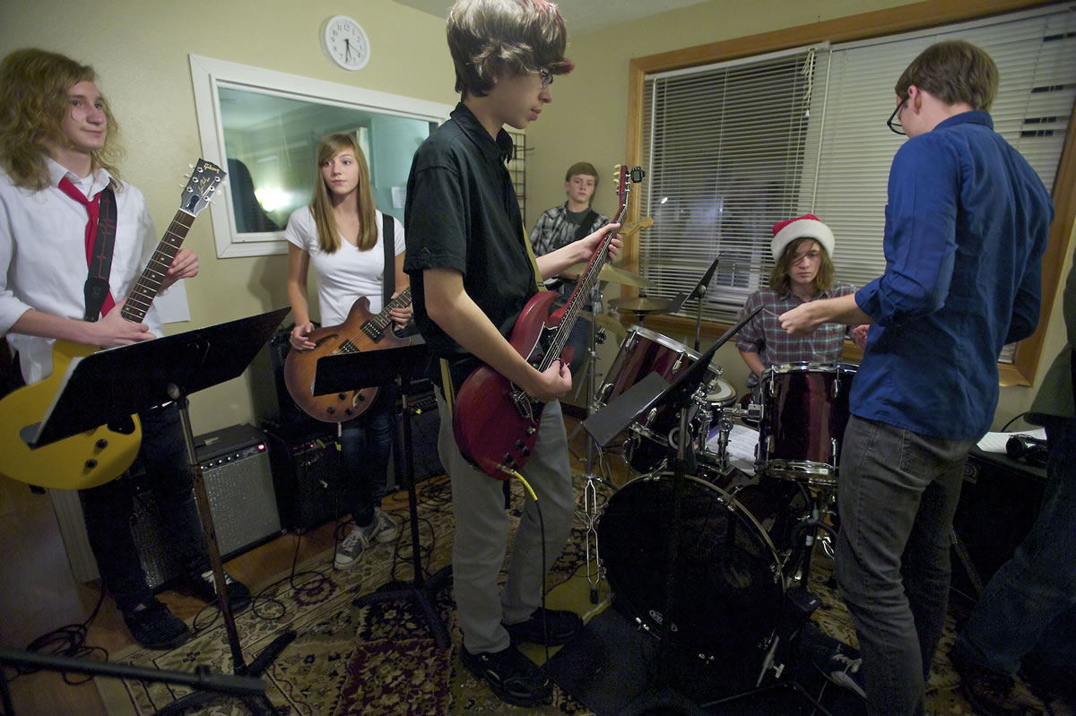 Music students at The Opus School of Music in Ridgefield prepare for a gig at the Holiday Gift Fair and, eventually, the Autumnal Concert in December, under the guidance of guitar teacher Kyle Williams, right.