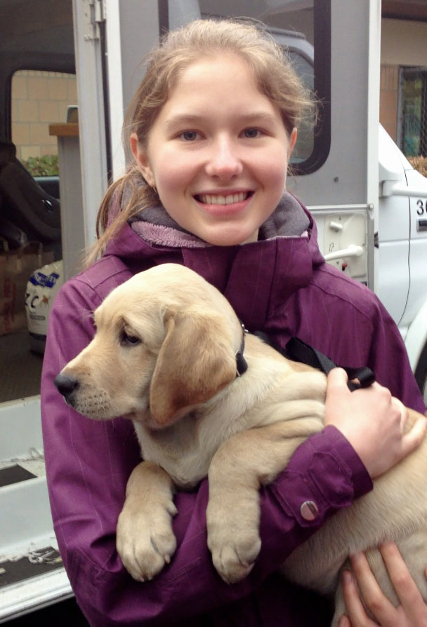 Kristen Granger, 17, holds Vista, a guide dog in training she helped raise, in December 2011.