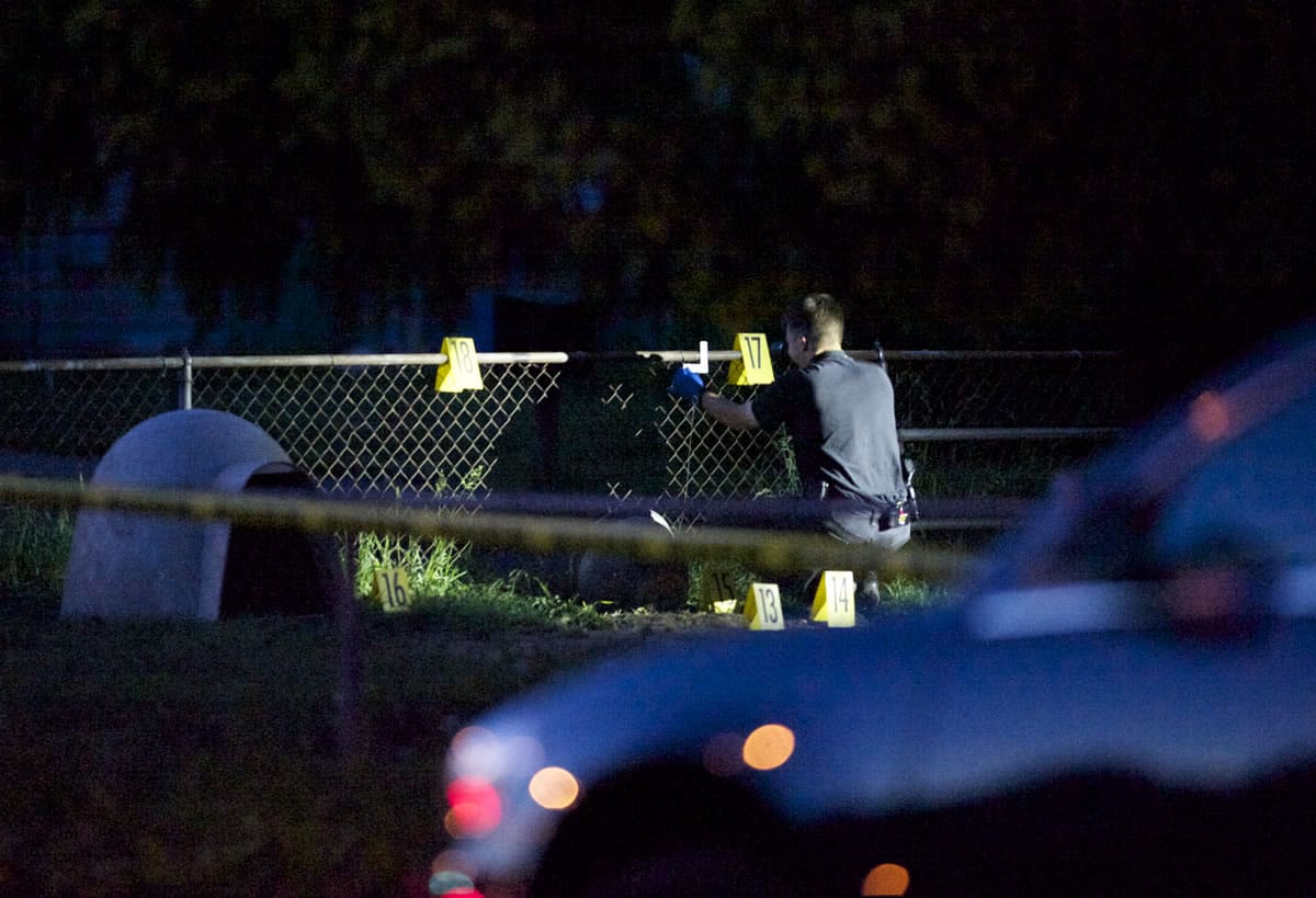 Police worked well into the evening processing evidence at the scene of a fatal shooting May 9 in the yard of a home at the intersection of West 27th Avenue and Fruit Valley Road.