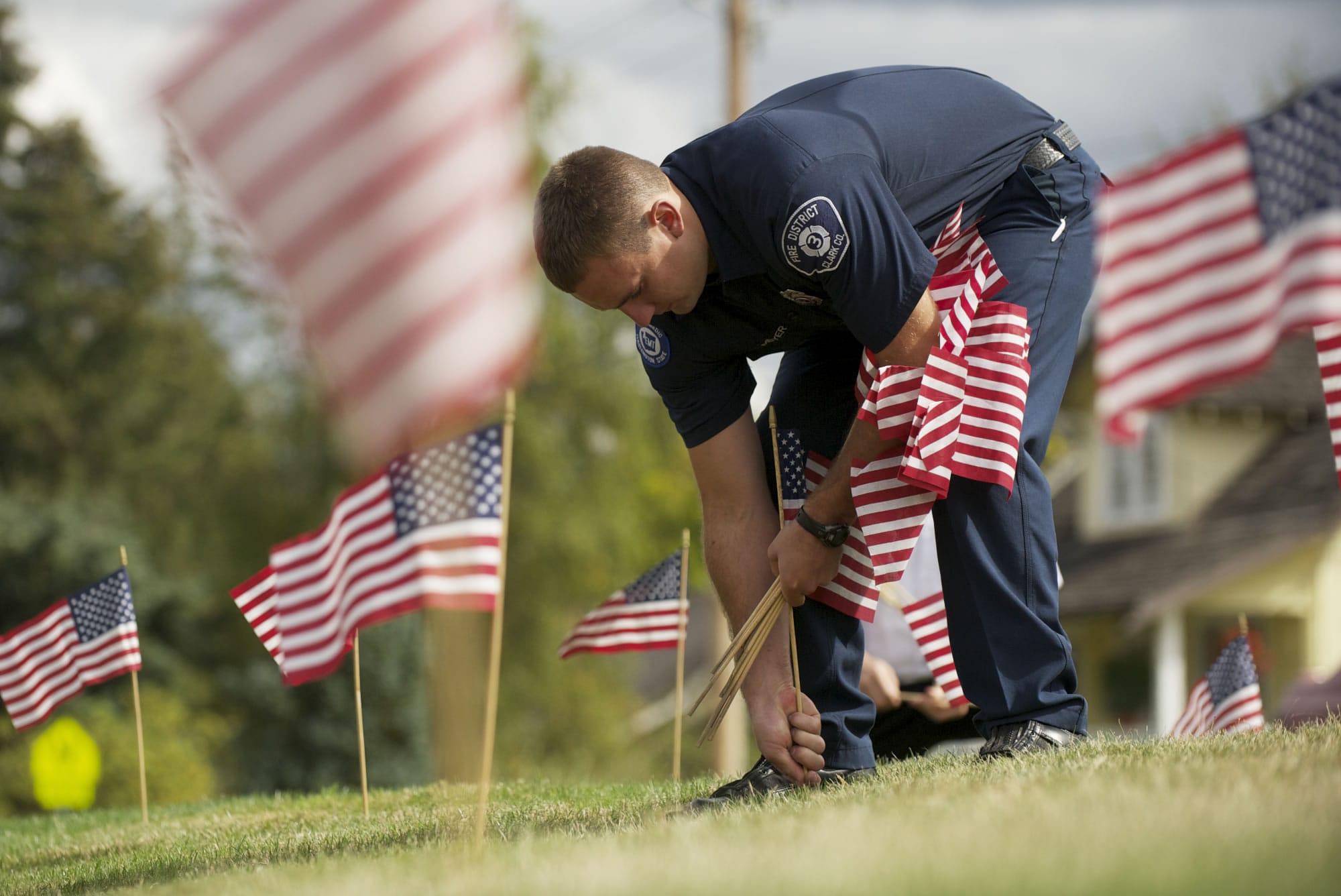 Nolan Meyer and other Clark County Fire District 3 firefighters planted 304 American flags in front of the Hockinson station Monday in remembrance of the Sept. 11 attacks. A commemoration will be held at 6:58 a.m. today at the station, 17718 N.E.