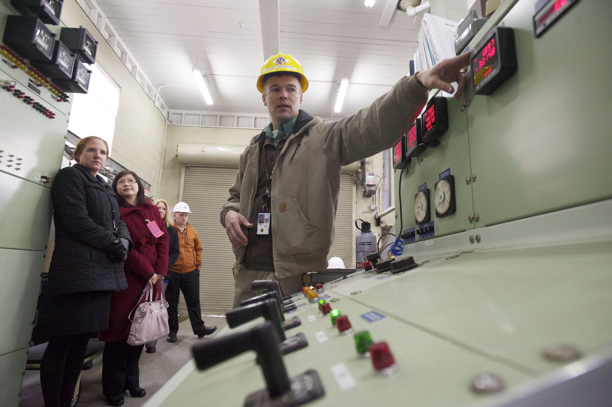 BPA electrical engineer Jeff Hildreth, center, leads a tour on Jan.