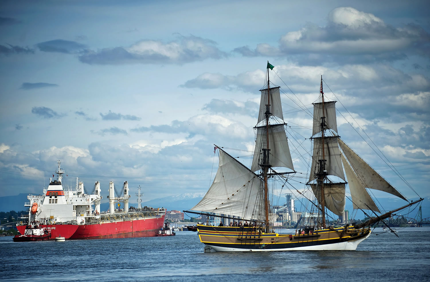 The Lady Washington gets out of the path of a large commercial ship during a battle sail on the Columbia River.