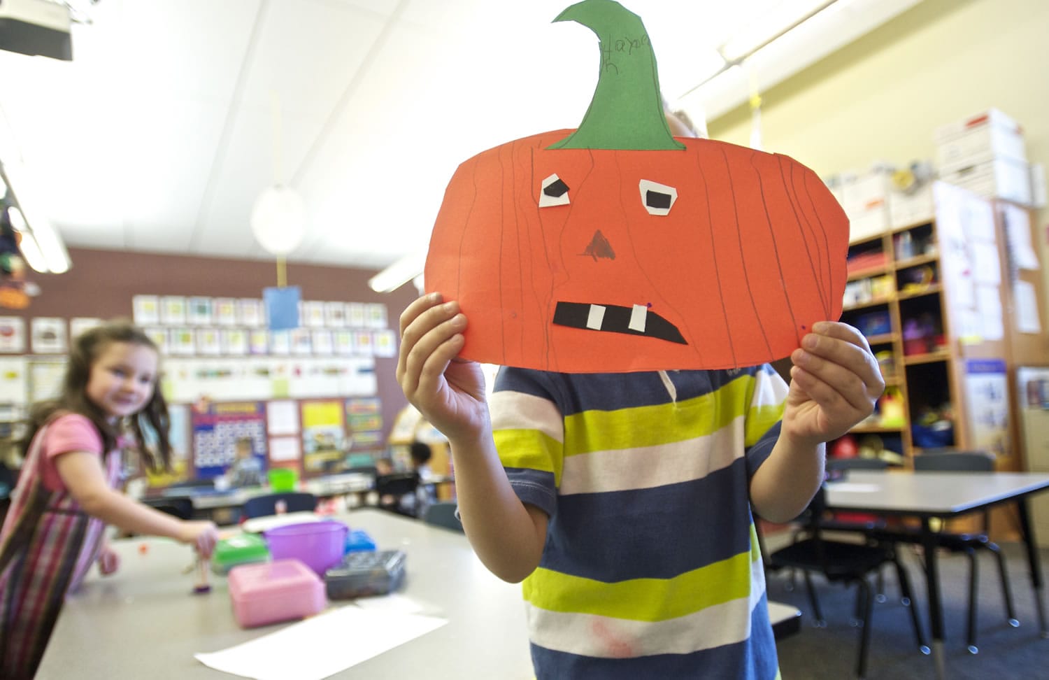 Hayden Crouse, 5, shows off a paper jack-o'-lantern he crafted in Laura Tomberlin's classroom on Oct. 22 at La Center Elementary School.