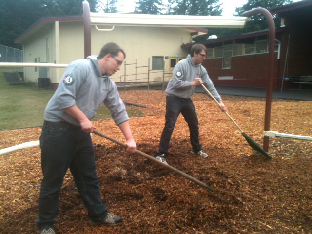 Meadow Homes: Washington Reading Corps volunteers Dennis Bogle, left, and Jesse Krause spread mulch March 15 at Carson Elementary School in Carson.