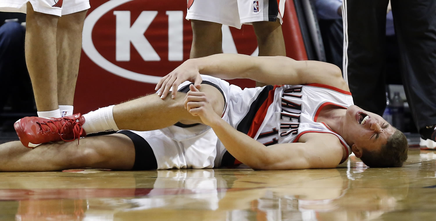Portland Trail Blazers center Meyers Leonard reacts after injuring his right ankle during the second half Saturday.