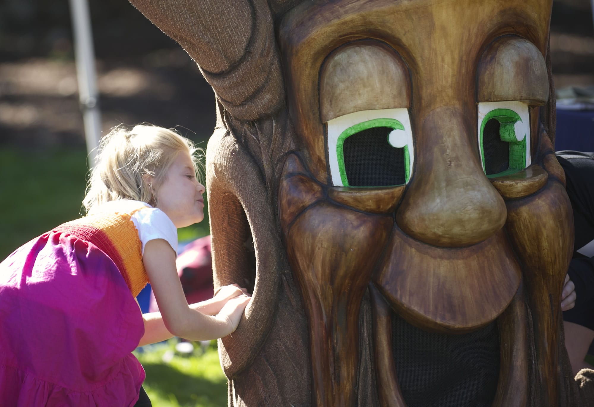 Natalie Oneil, 7, of Vancouver, looks inside an empty tree costume at the Old Apple Tree Festival on Saturday.