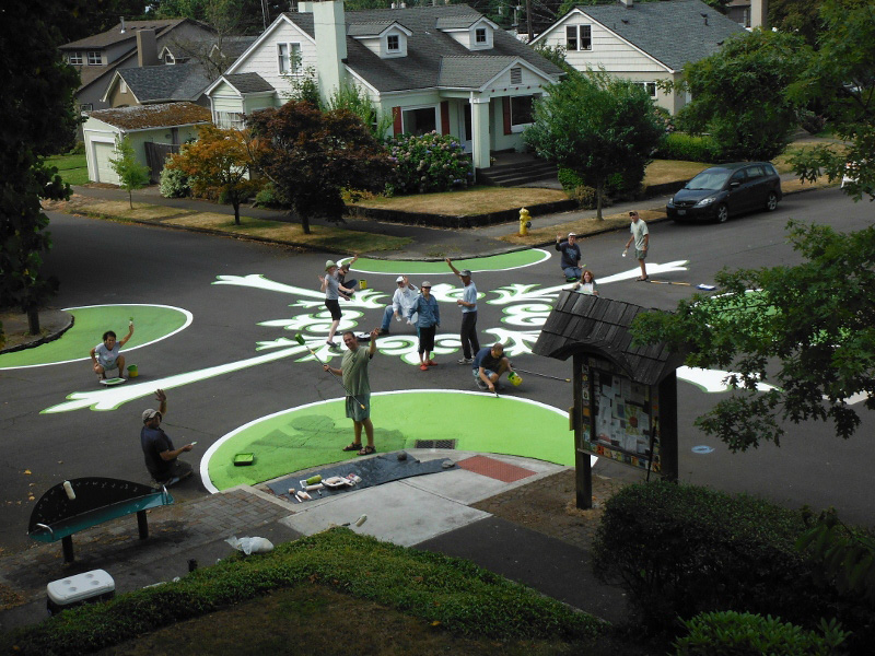 Arnada: This upper-story view shows the volunteer crew retouching the fleur-de-lis patterned street mural at 22nd and D streets.