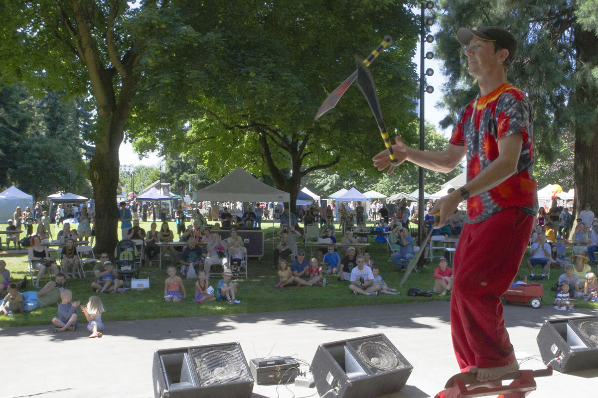 Rhys Thomas juggles knives while standing on swords.