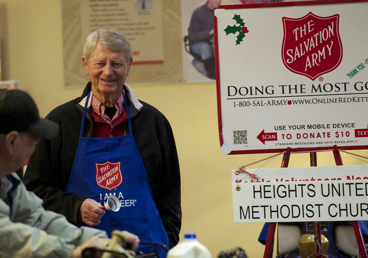Salvation Army bell ringer Chuck Mulligan, who has been volunteering for the seasonal position for about 50 years, collects donations at Fred Meyer in east Vancouver  on Dec.