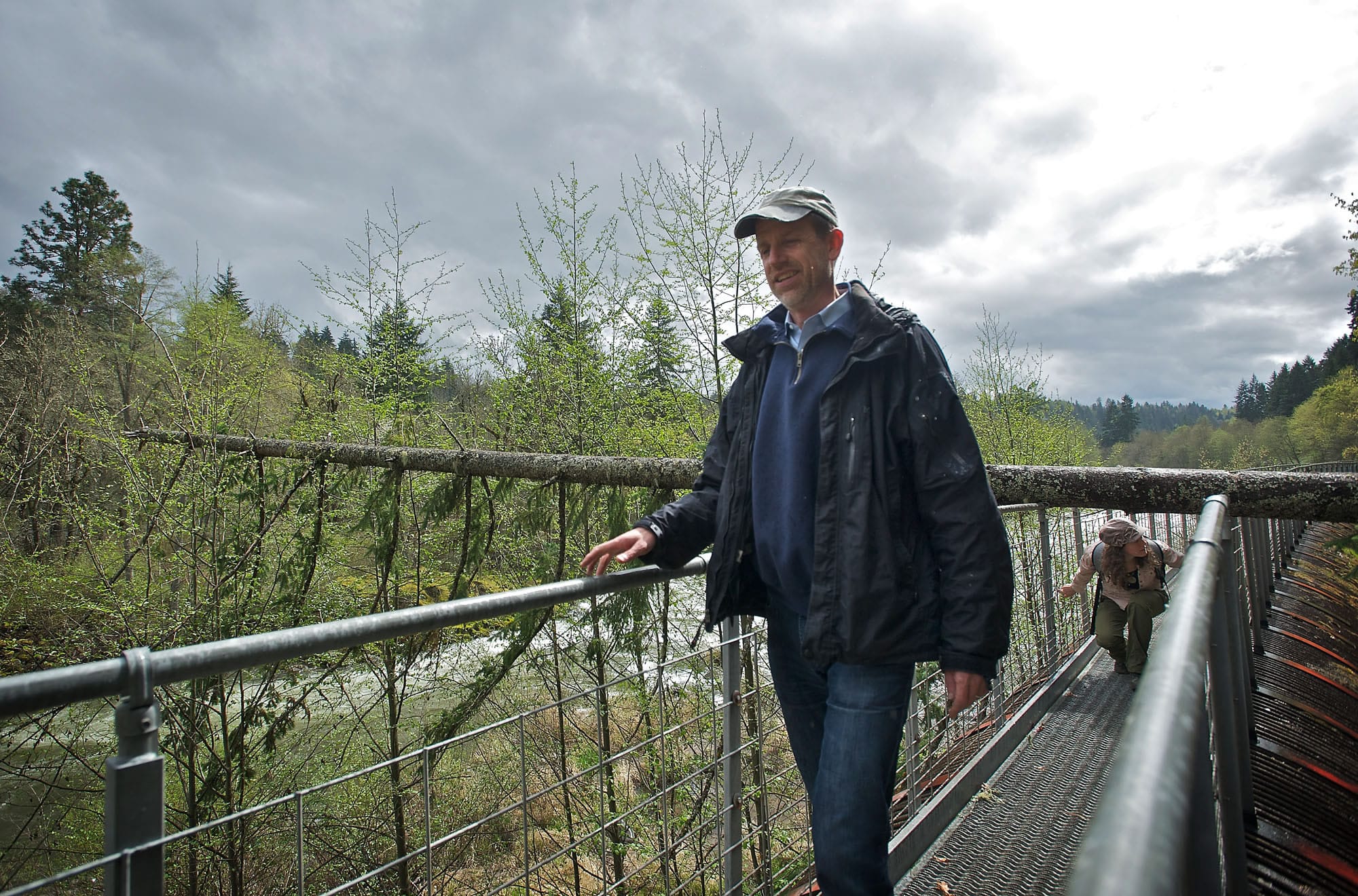 Columbia Land Trust Executive Director Glenn Lamb, foreground, and stewardship lead Kate Conley walk along a pipeline from an old dam on the Hood River in Oregon.